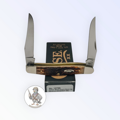 Case XX Muskrat with jigged amber bone and twin spey blades, SKU 10798 — blades open resting on the factory box