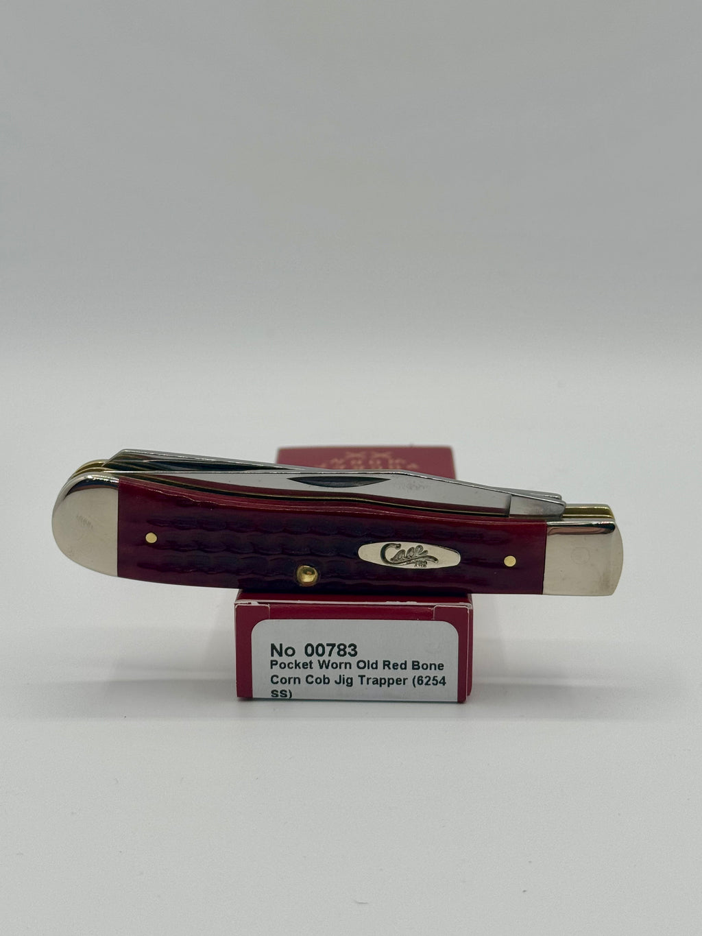 Case XX 00783 Pocket Worn Red Bone Trapper — lifestyle angle on Case box