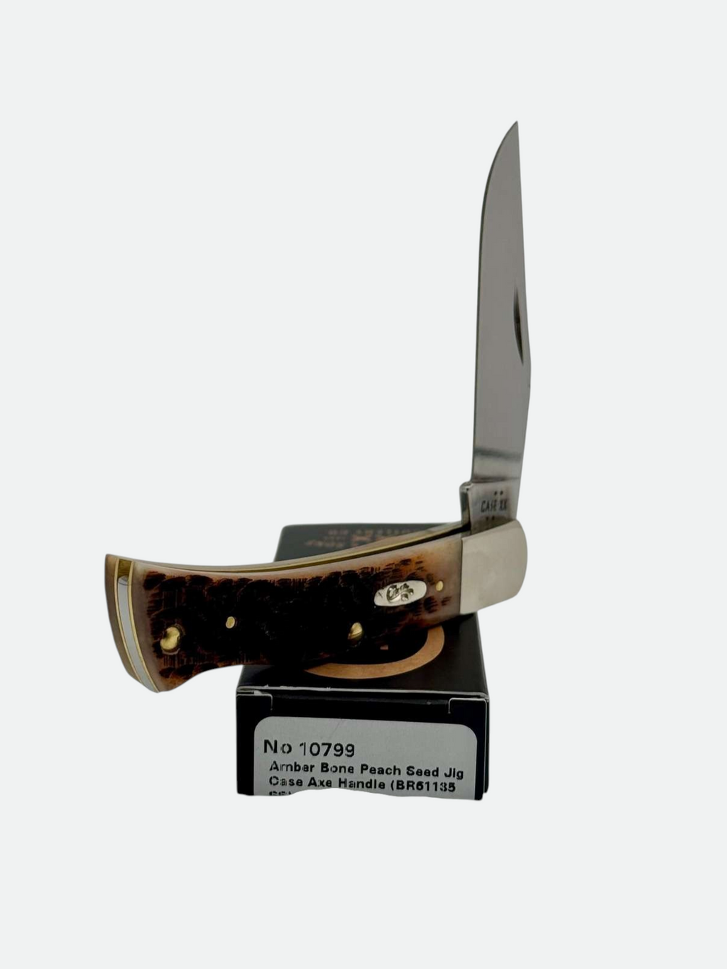 Pigeon Roost Knives Case XX Axe Handle pocket knife with amber bone peach seed jig scales and a clip blade