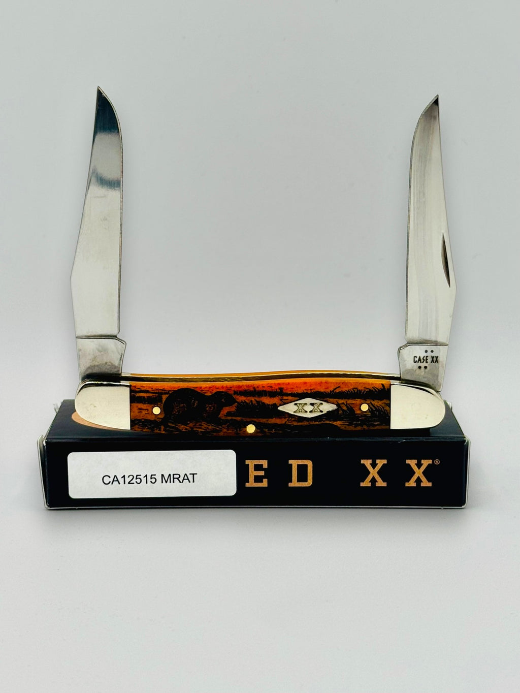 Case XX 12517MRAT Muskrat Engraving Red Bone — closed on Case box