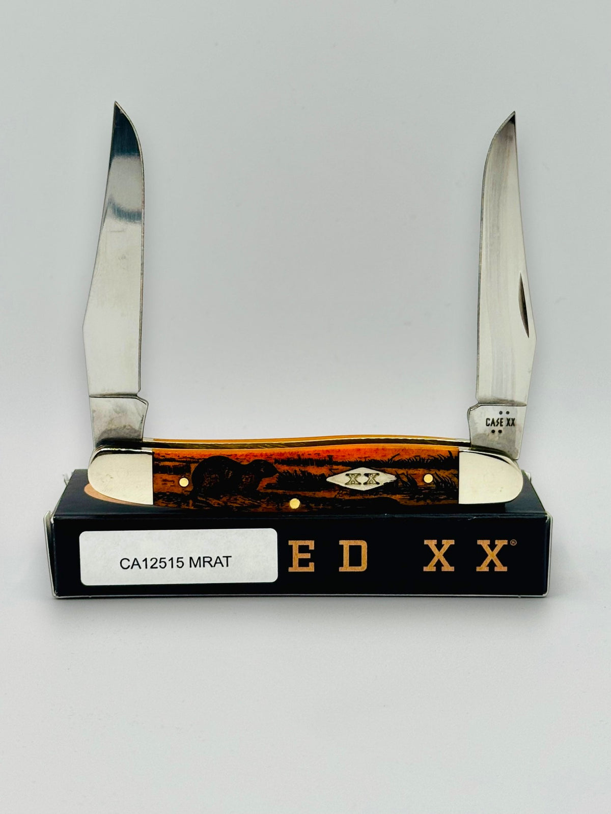 Case XX 12517MRAT Muskrat Engraving Red Bone — closed on Case box