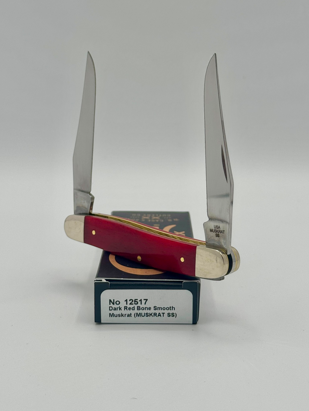 Case XX 12517 Smooth Red Bone Muskrat — handle and shield detail