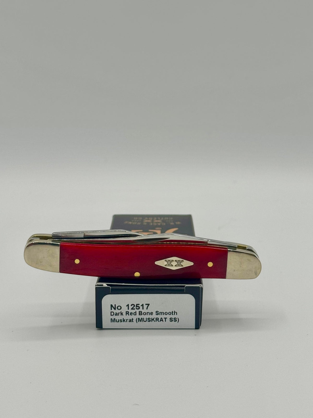 Case XX 12517 Smooth Red Bone Muskrat — lifestyle angle on Case box