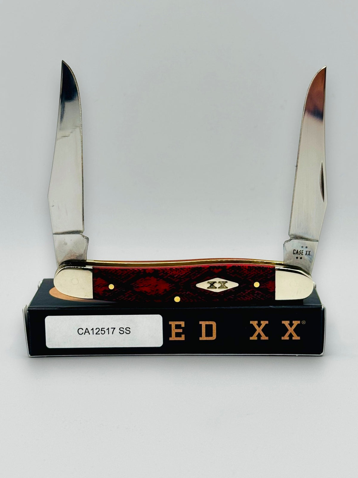 Case XX 12517SS Muskrat Snake Skin Red Bone — open on Case box