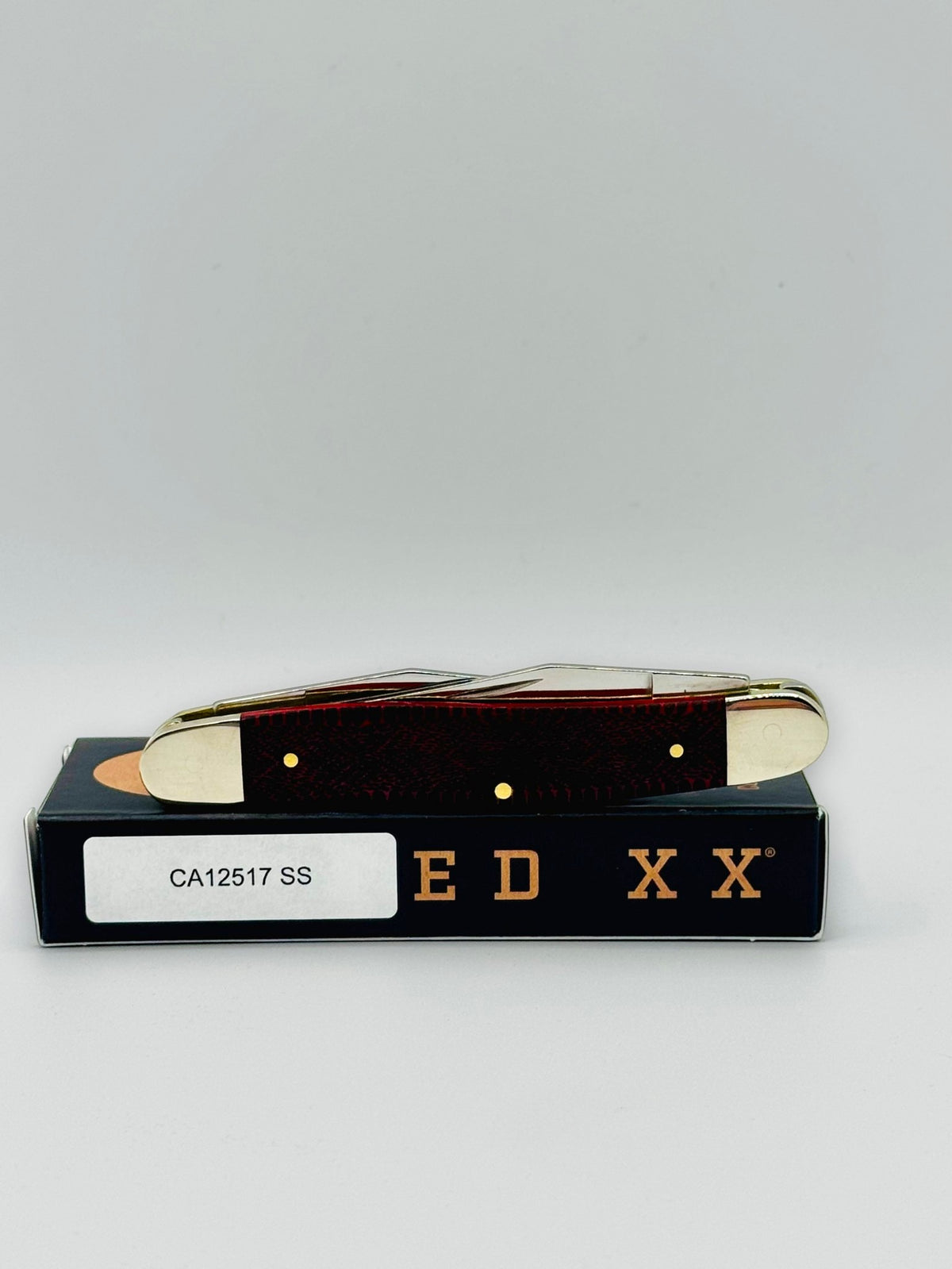 Case XX 12517SS Muskrat Snake Skin Red Bone — closed on Case box