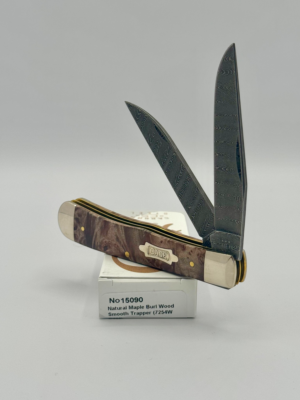 Case XX 15090 Natural Maple Burl Wood Ladder Damascus Trapper — closed on Case box