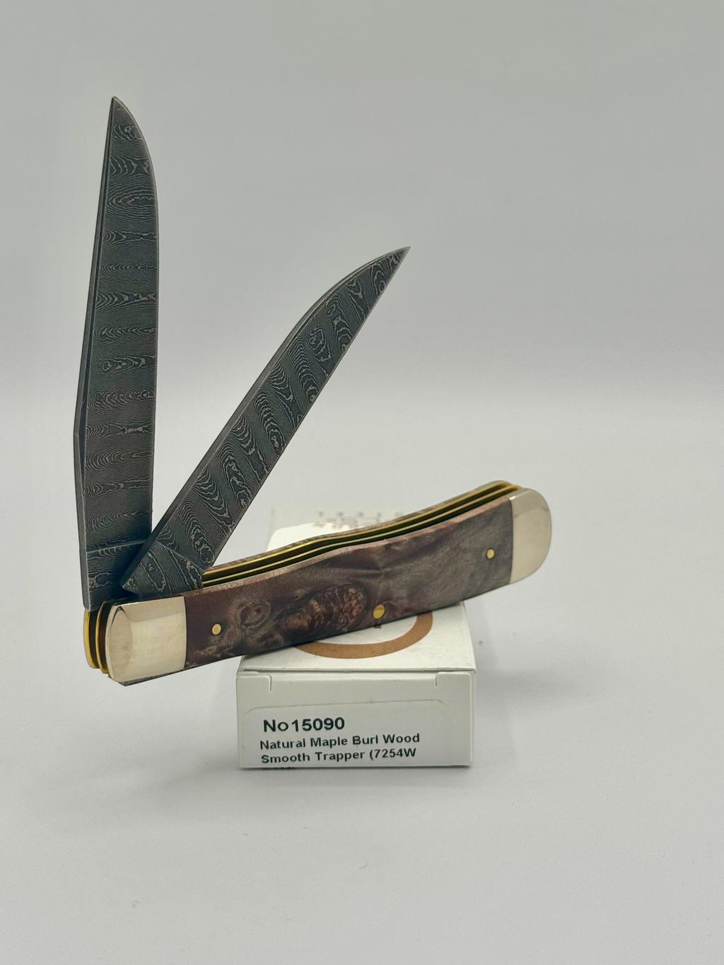 Case XX 15090 Natural Maple Burl Wood Ladder Damascus Trapper — back side on Case box