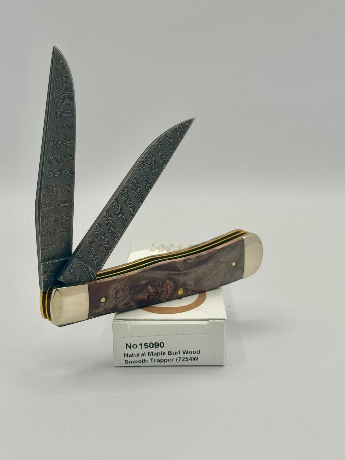 Case XX 15090 Natural Maple Burl Wood Ladder Damascus Trapper — back side on Case box