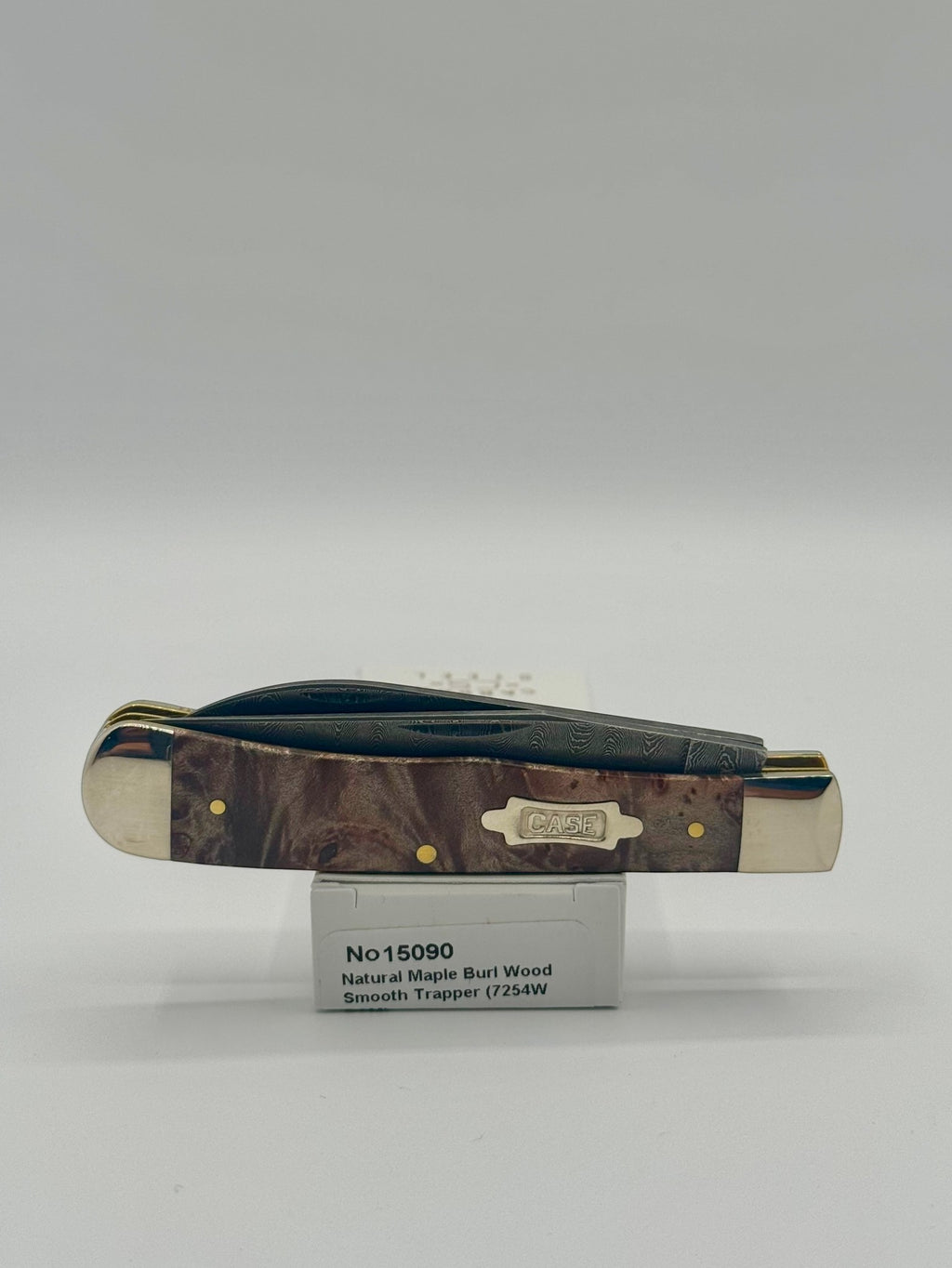 Case XX 15090 Natural Maple Burl Wood Ladder Damascus Trapper — lifestyle angle on Case box