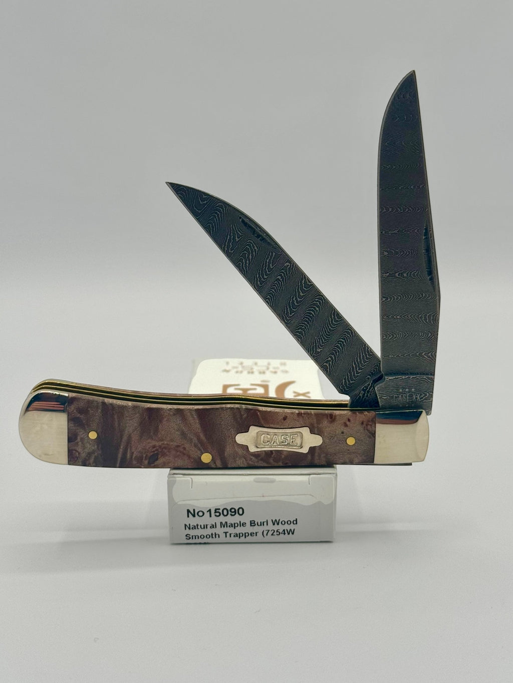 Case XX 15090 Natural Maple Burl Wood Ladder Damascus Trapper — open on Case retail box