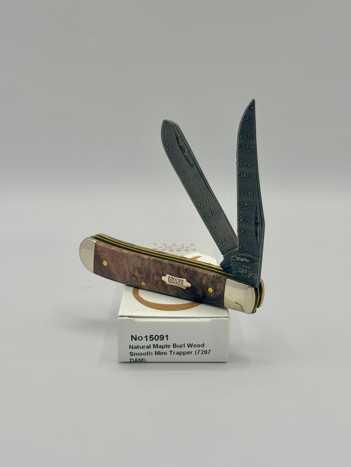 Case XX 15091 Natural Maple Burl Wood Ladder Damascus Mini Trapper — closed on Case box