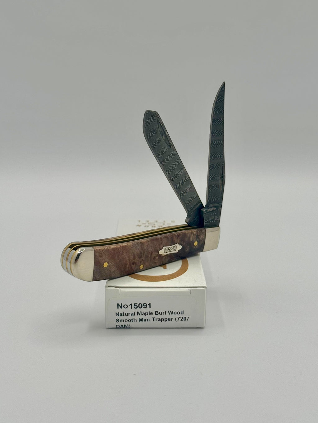 Case XX 15091 Natural Maple Burl Wood Ladder Damascus Mini Trapper — blade detail on Case box