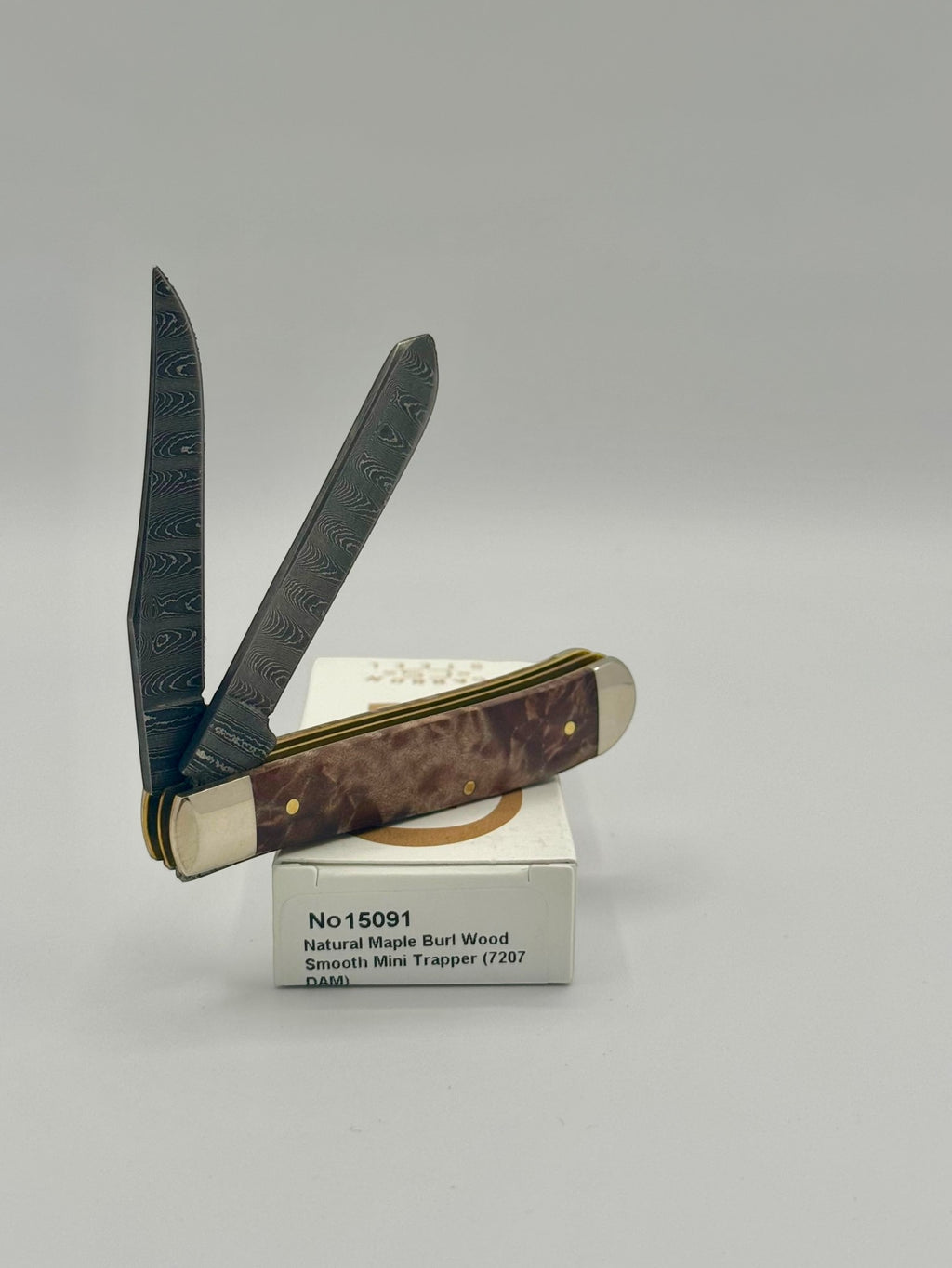 Case XX 15091 Natural Maple Burl Wood Ladder Damascus Mini Trapper — back side on Case box