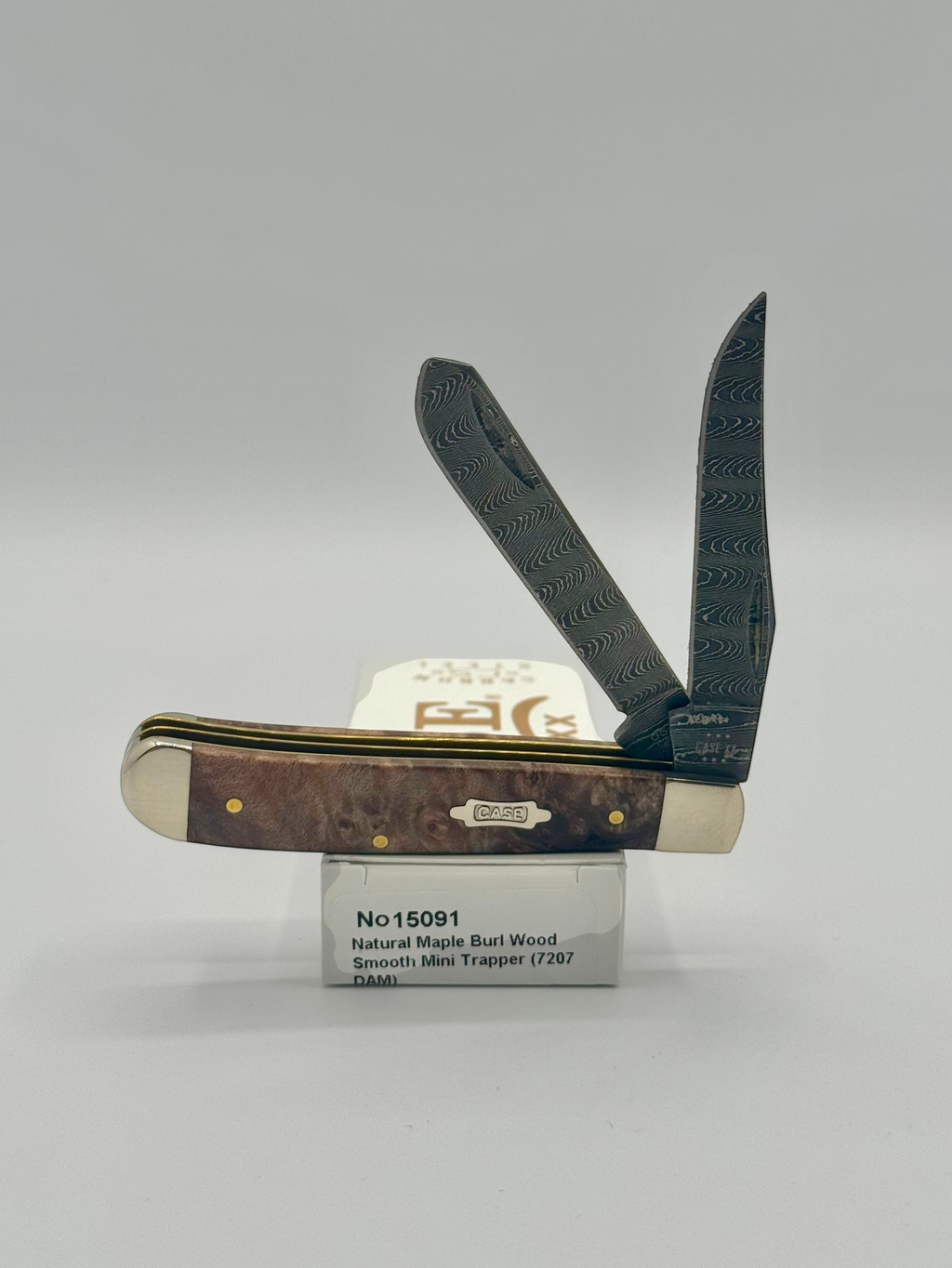 Case XX 15091 Natural Maple Burl Wood Ladder Damascus Mini Trapper — open on Case retail box