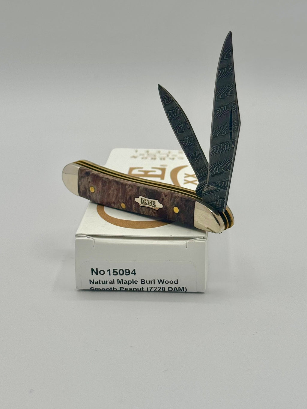 Case XX 15094 Smooth Natural Maple Burl Wood Damascus Peanut — closed on Case box