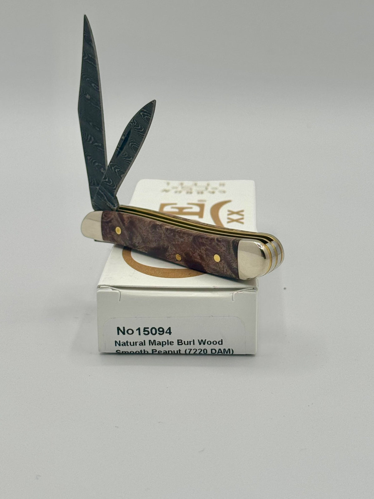 Case XX 15094 Smooth Natural Maple Burl Wood Damascus Peanut — handle and shield detail