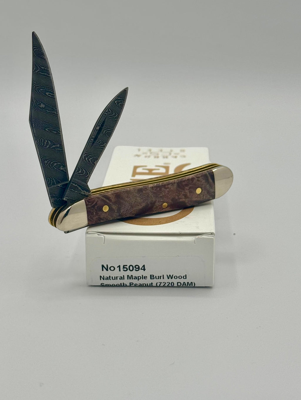 Case XX 15094 Smooth Natural Maple Burl Wood Damascus Peanut — back side on Case box