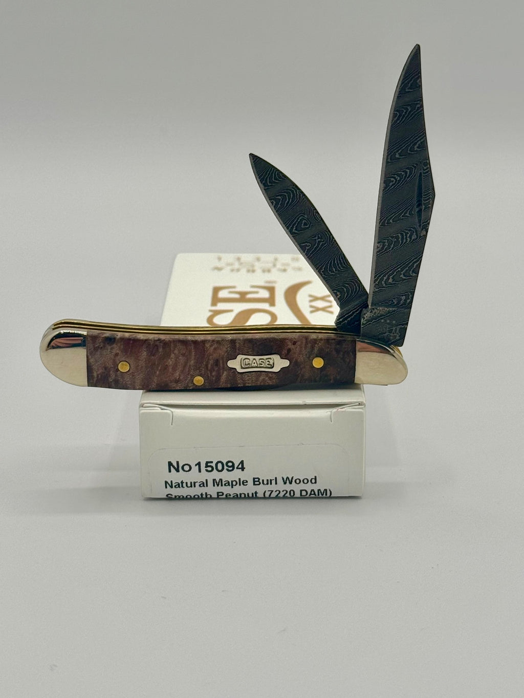 Case XX 15094 Smooth Natural Maple Burl Wood Damascus Peanut — open on Case retail box