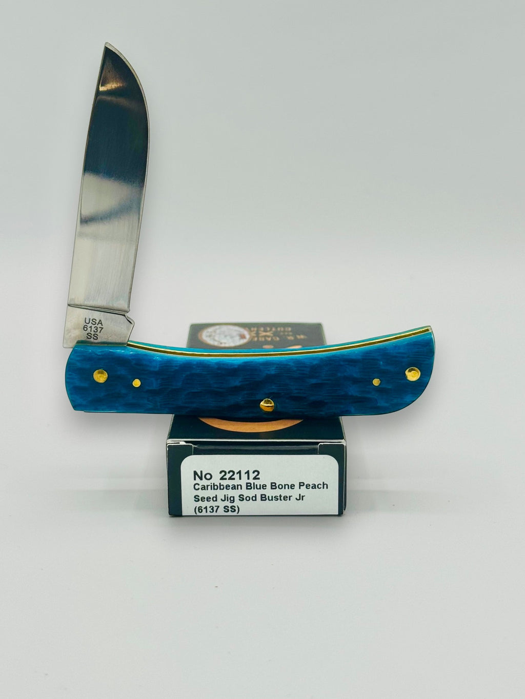 Case XX 22112 Sod Buster Jr Caribbean Blue Bone — angled open on Case box