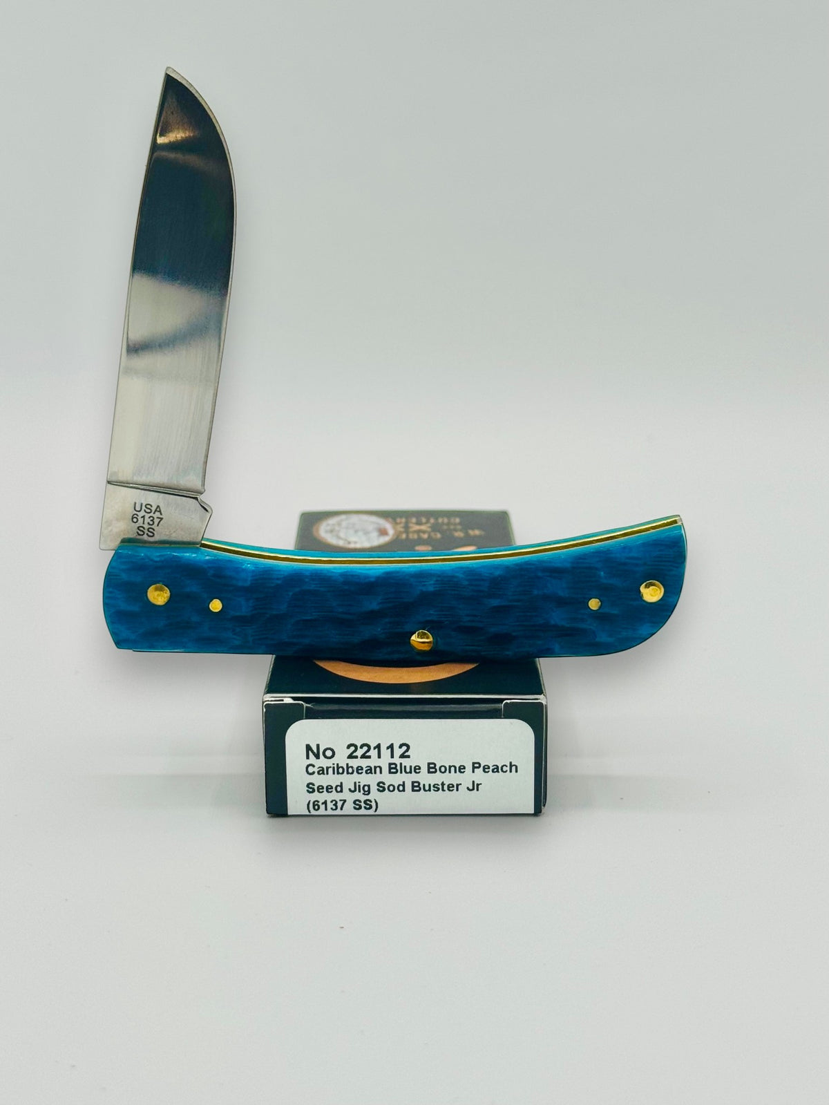 Case XX 22112 Sod Buster Jr Caribbean Blue Bone — angled open on Case box