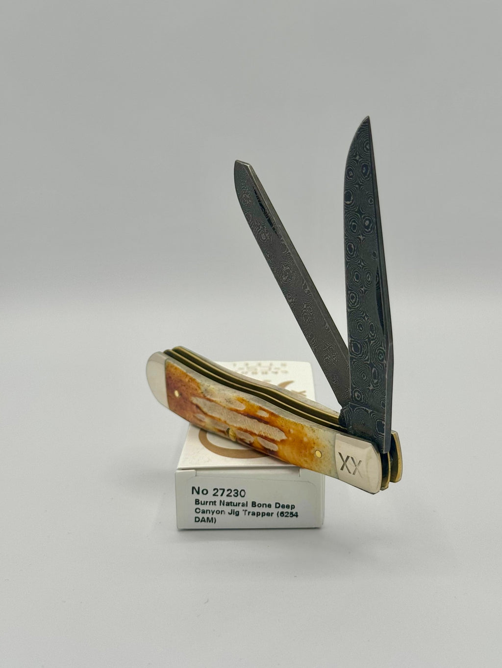 Case XX 27230 Damascus Burnt Natural Bone Deep Canyon Jig Trapper — closed on Case box