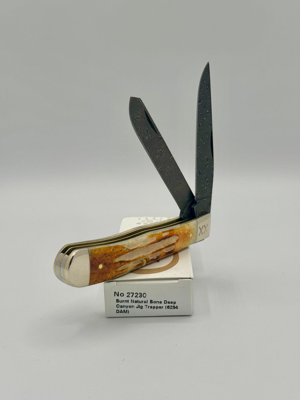 Case XX 27230 Damascus Burnt Natural Bone Deep Canyon Jig Trapper — blade detail on Case box