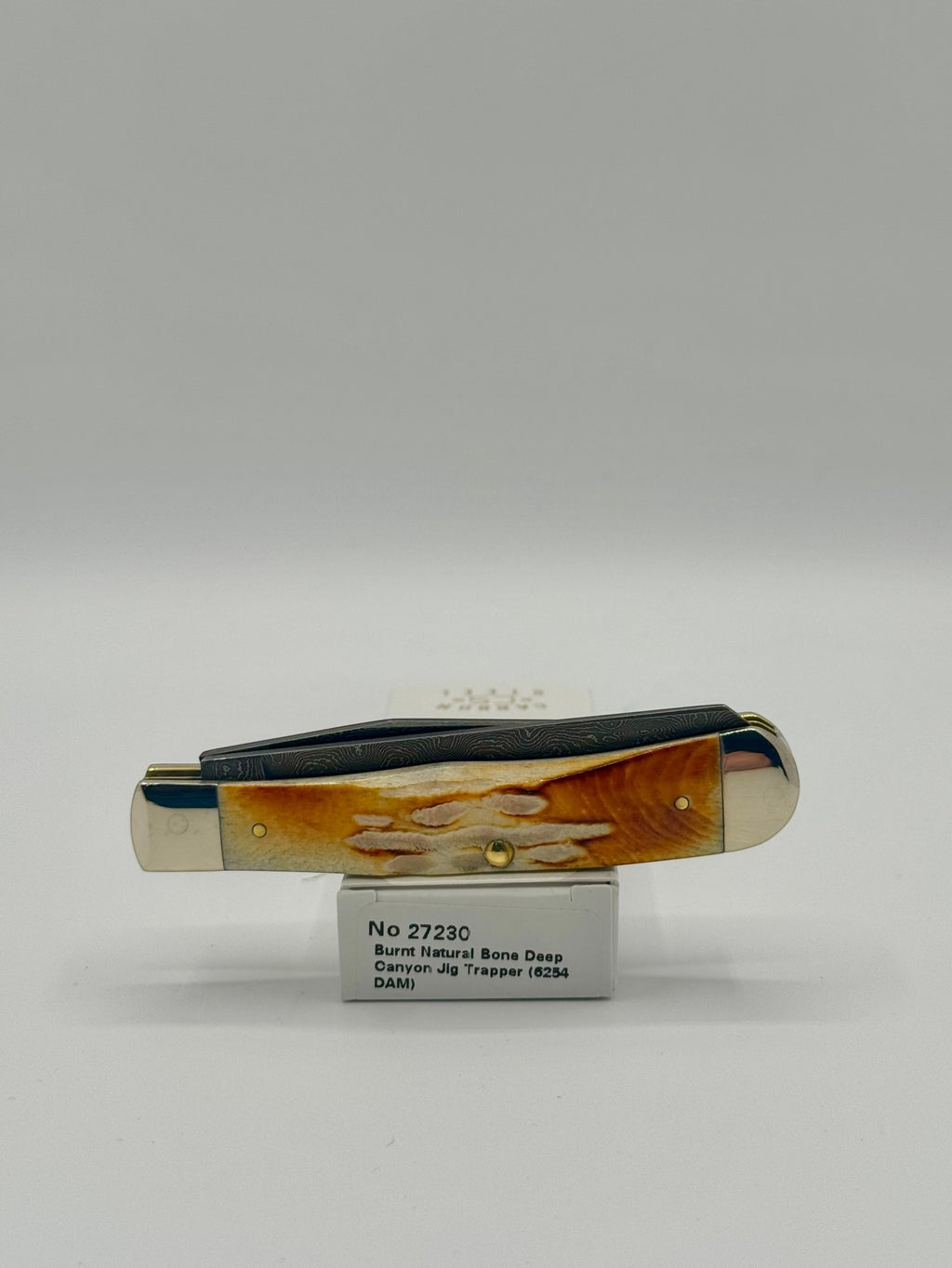 Case XX 27230 Damascus Burnt Natural Bone Deep Canyon Jig Trapper — packaging and knife together