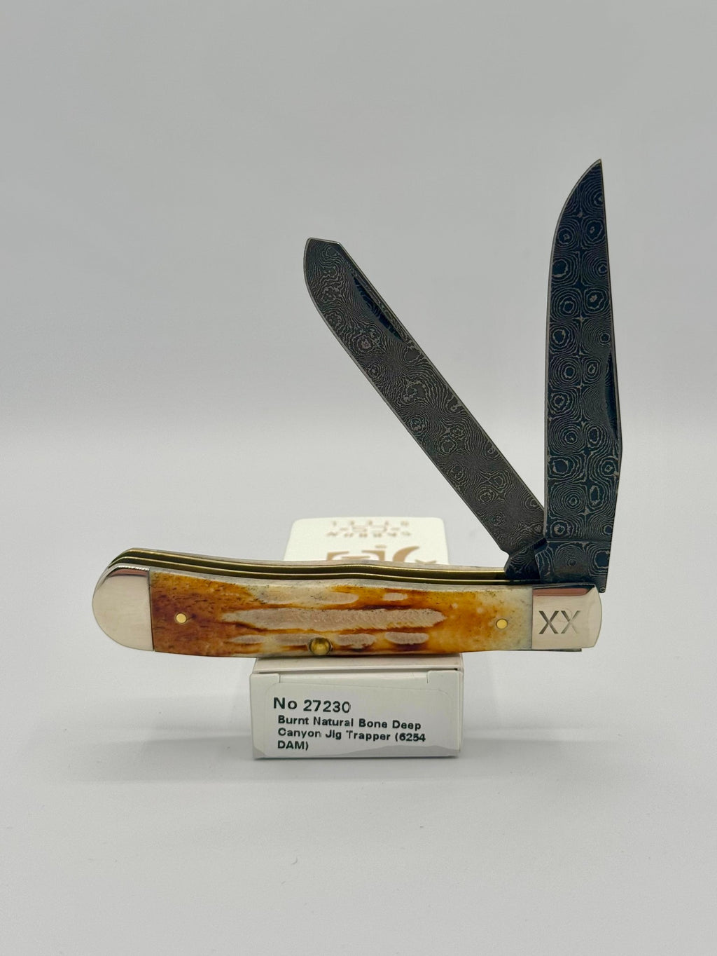 Case XX 27230 Damascus Burnt Natural Bone Deep Canyon Jig Trapper — open on Case retail box