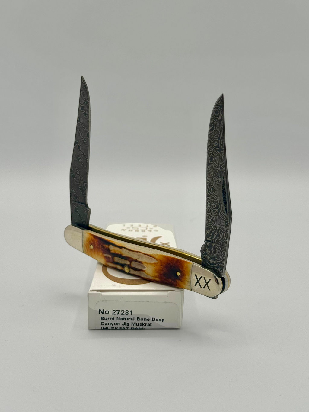 Case XX 27231 Damascus Burnt Natural Bone Deep Canyon Jig Muskrat — closed on Case box
