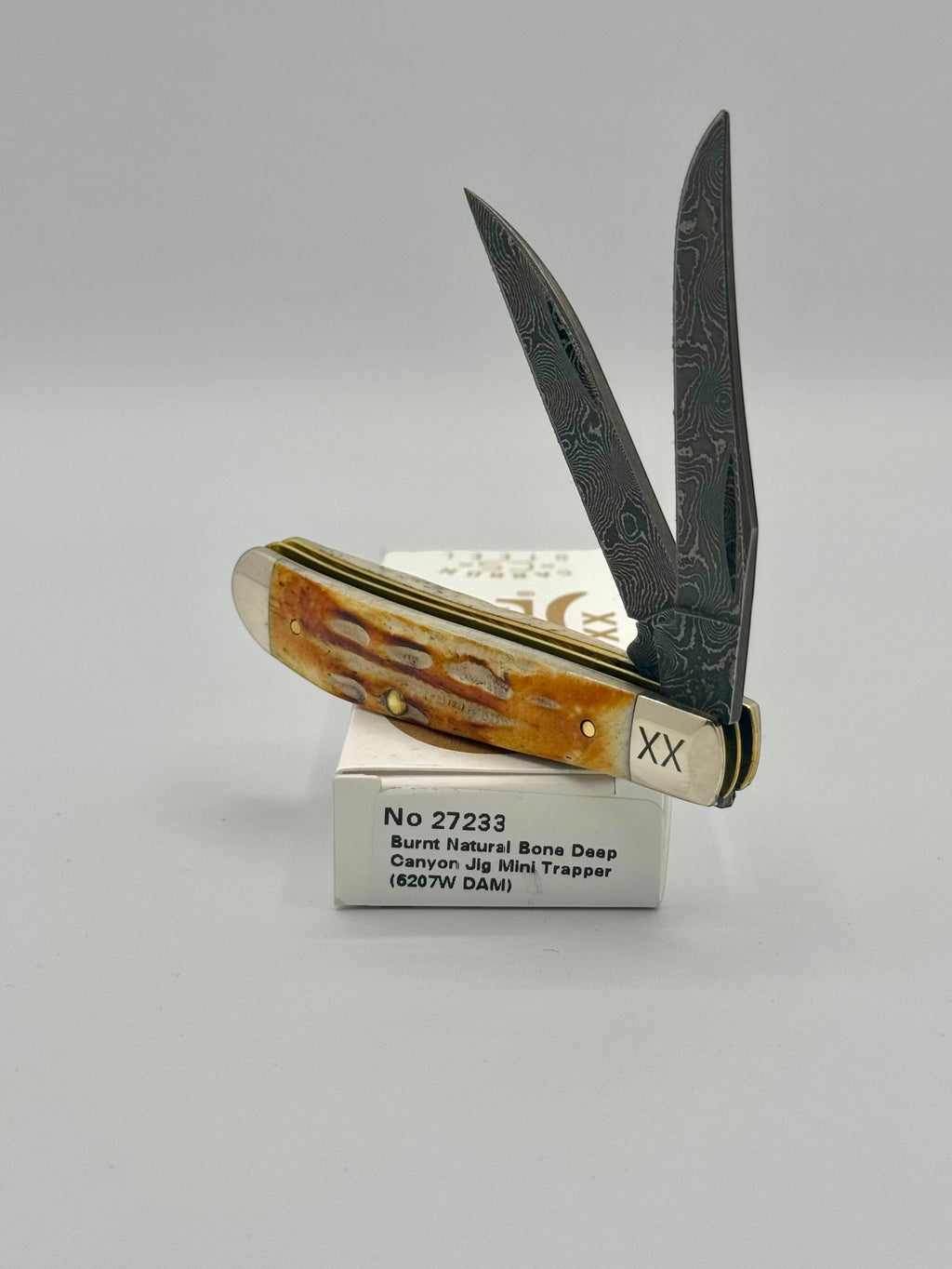 Case XX 27233 Damascus Burnt Natural Bone Deep Canyon Jig Mini Trapper — closed on Case box