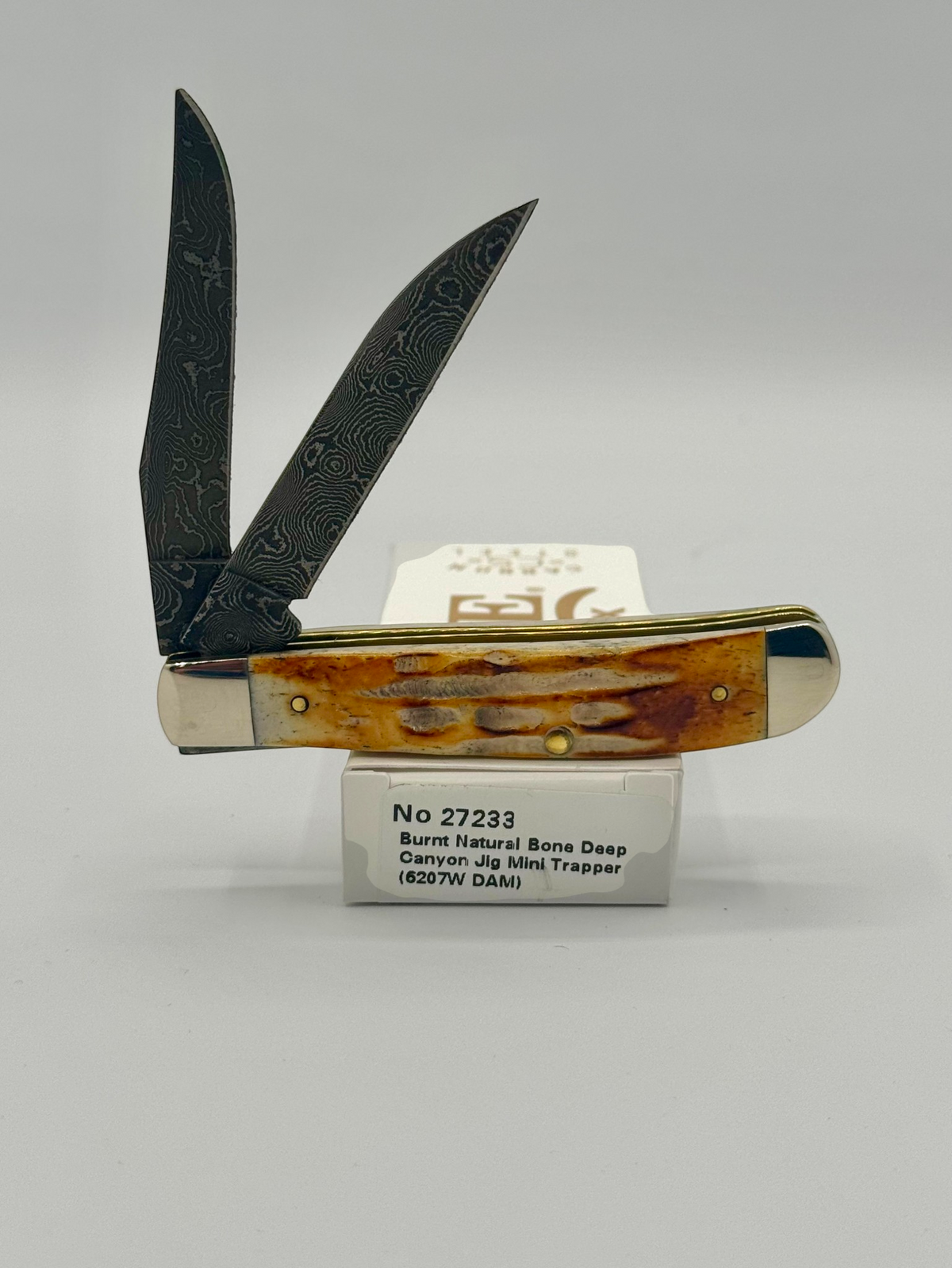 Case XX 27233 Damascus Burnt Natural Bone Deep Canyon Jig Mini Trapper — angled open view