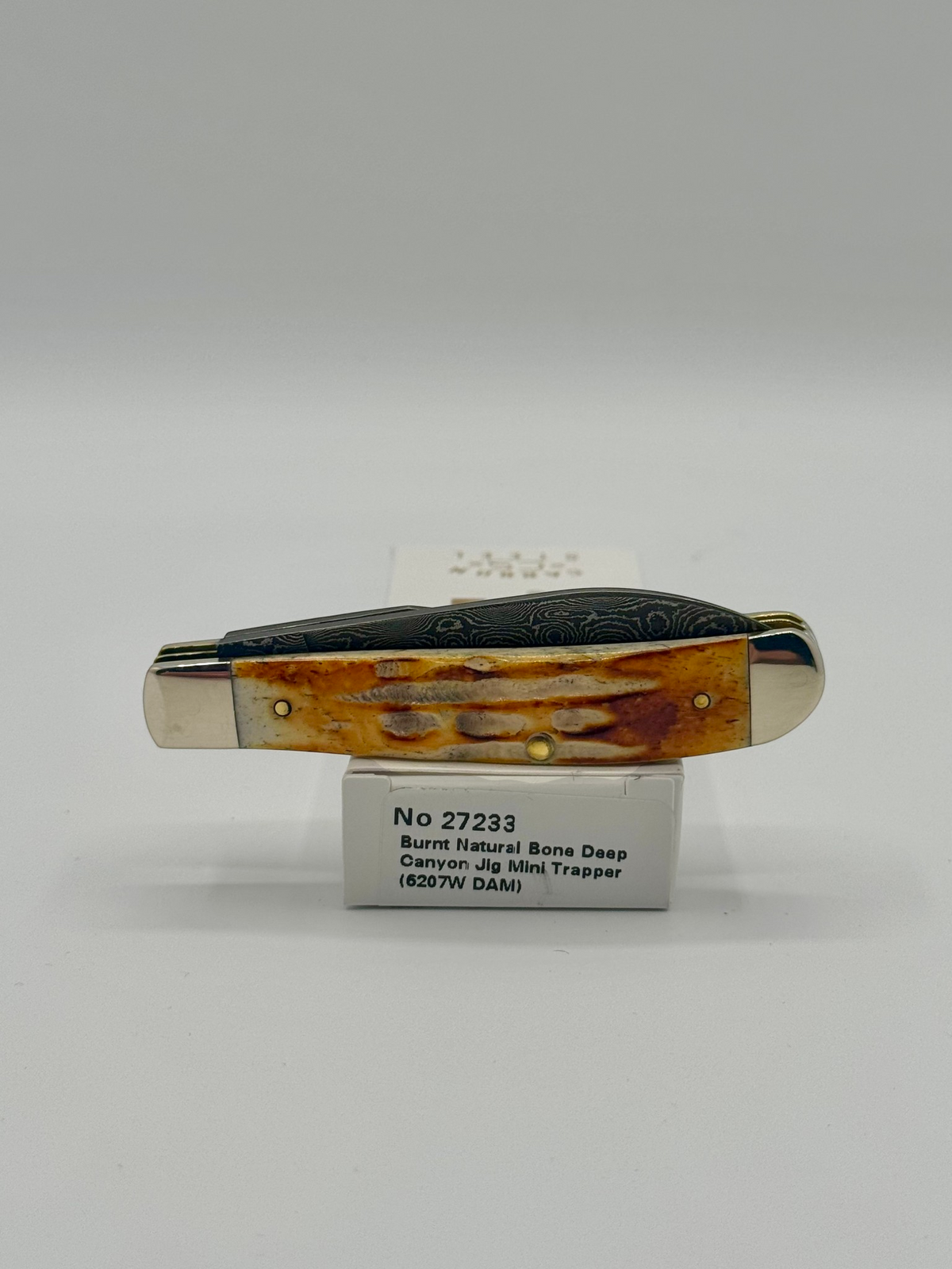 Case XX 27233 Damascus Burnt Natural Bone Deep Canyon Jig Mini Trapper — packaging and knife together