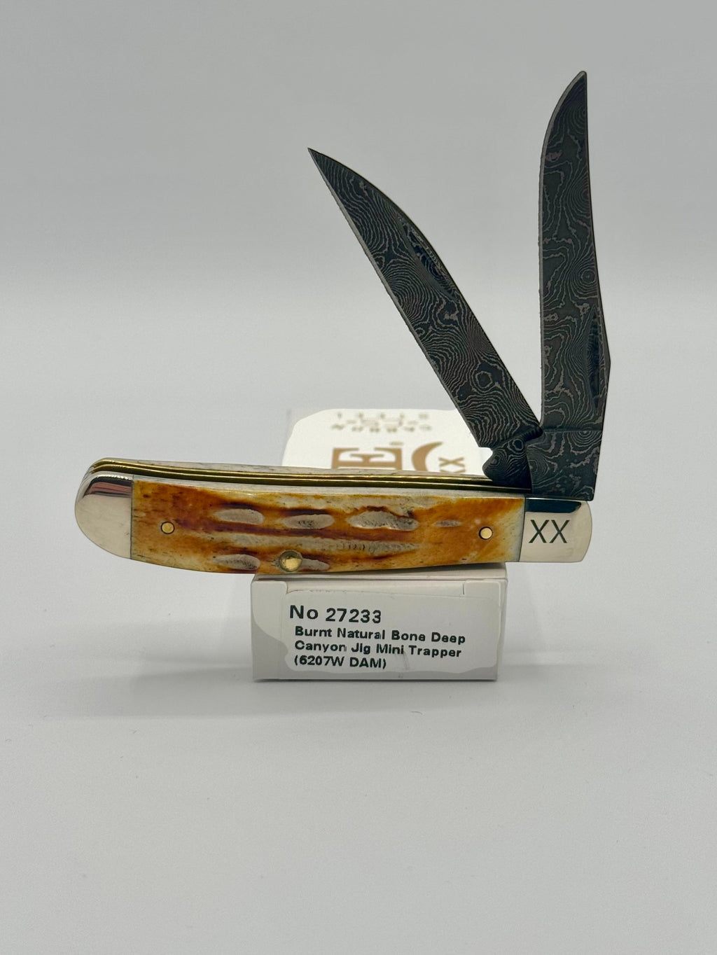 Case XX 27233 Damascus Burnt Natural Bone Deep Canyon Jig Mini Trapper — open on Case retail box