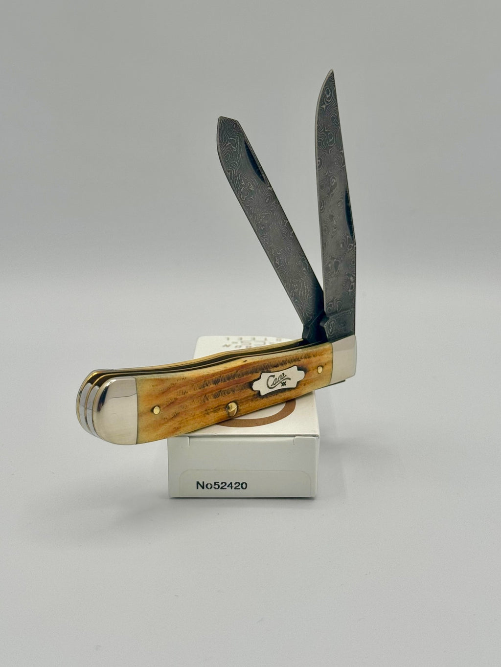 Case XX 52420 Burnt Goldenrod Second Cut Damascus Trapper — blade detail on Case box