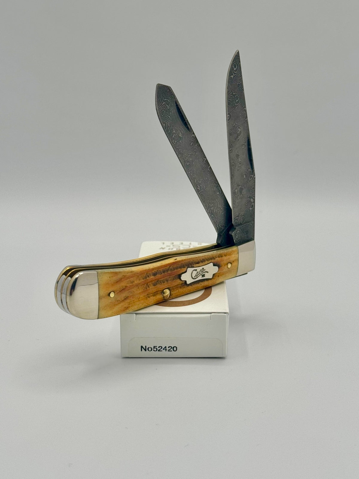 Case XX 52420 Burnt Goldenrod Second Cut Damascus Trapper — blade detail on Case box