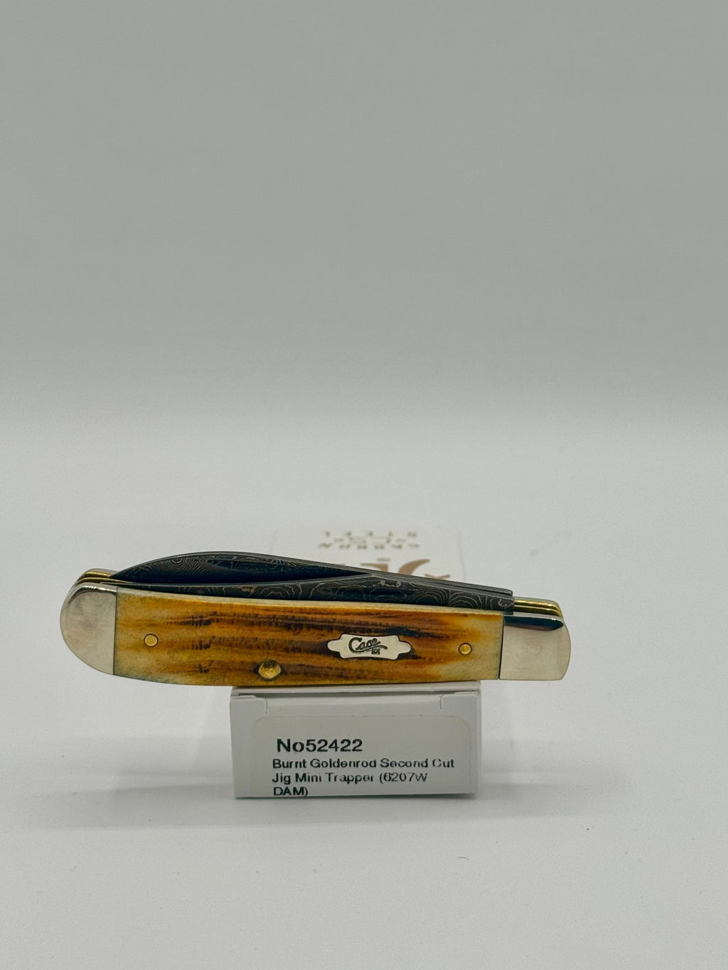 Case XX 52422 Burnt Goldenrod Second Cut Damascus Mini Trapper — lifestyle angle on Case box