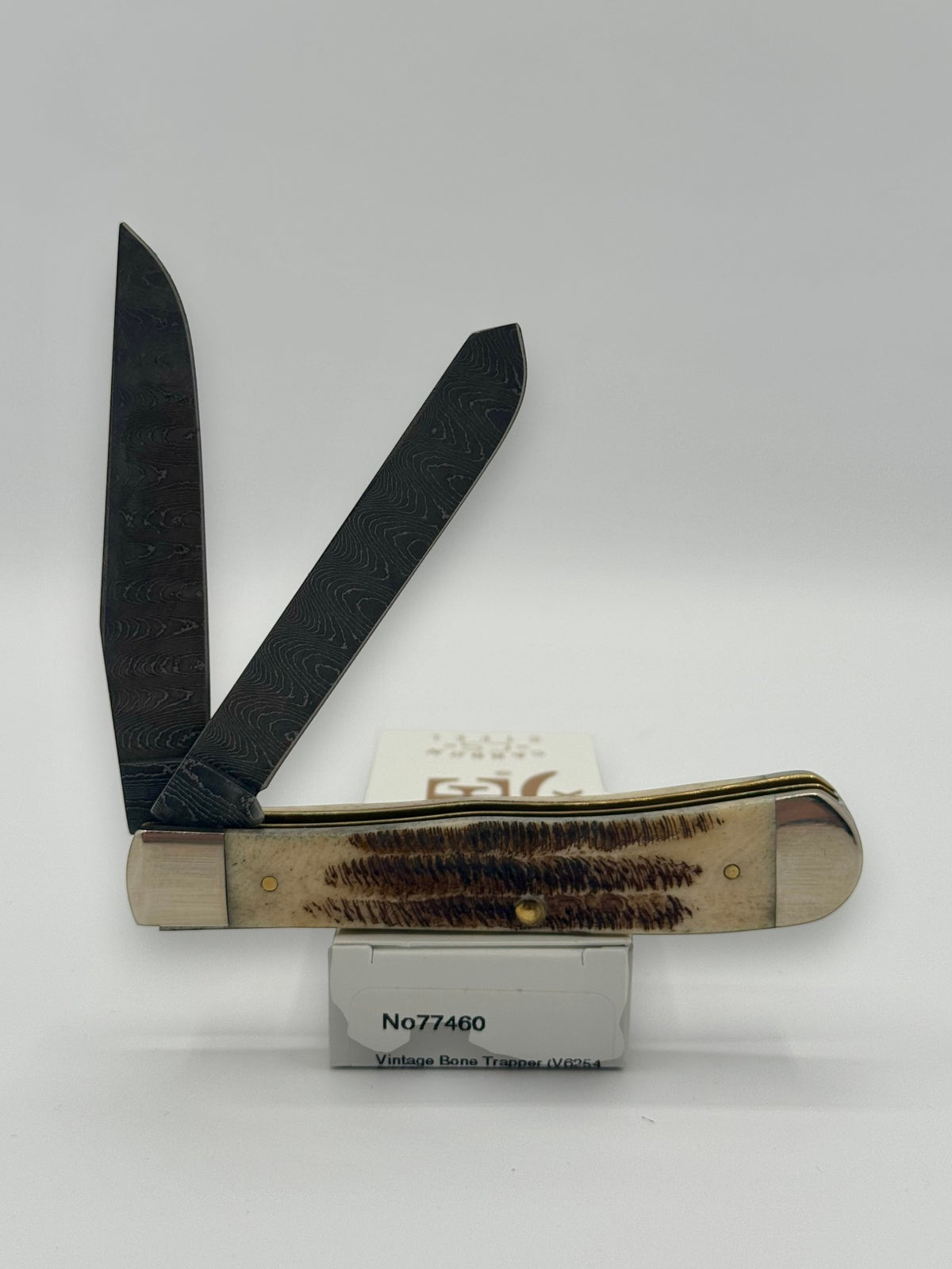 Case XX 77460 Vintage Bone Trapper Damascus — lifestyle angle on Case box