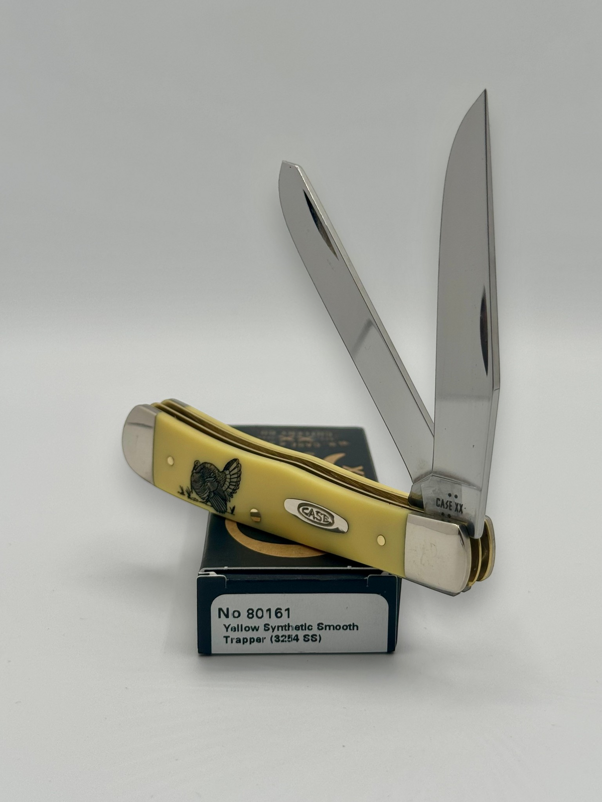 Case XX 80161T Turkey Yellow Syn Trapper — closed on Case box