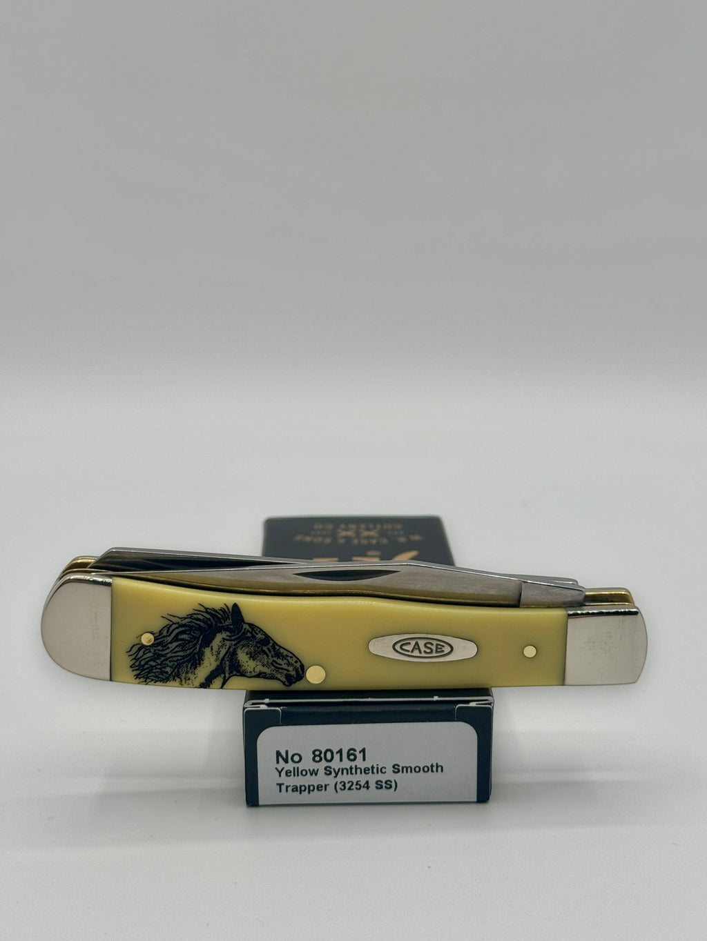 Case XX 80161WM Wild Mustang Yellow Syn Trapper — lifestyle angle on Case box
