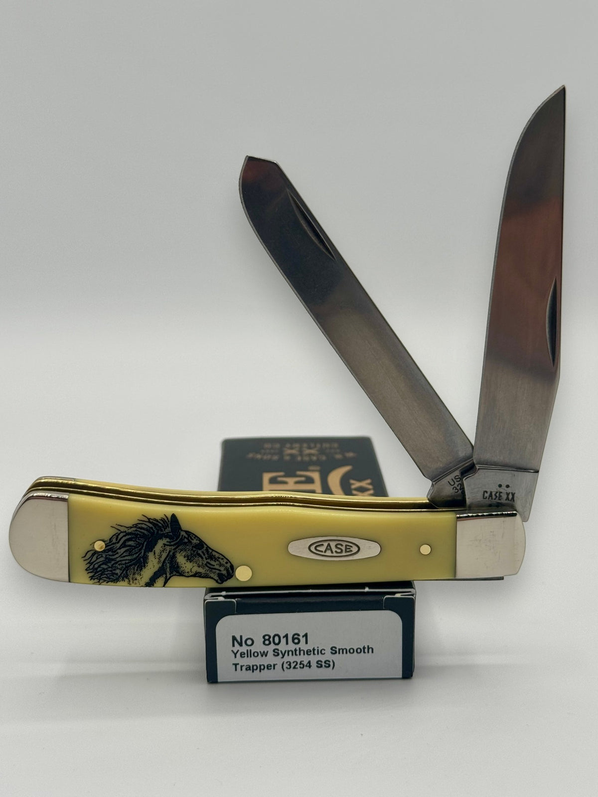 Case XX 80161WM Wild Mustang Yellow Syn Trapper — open on Case retail box