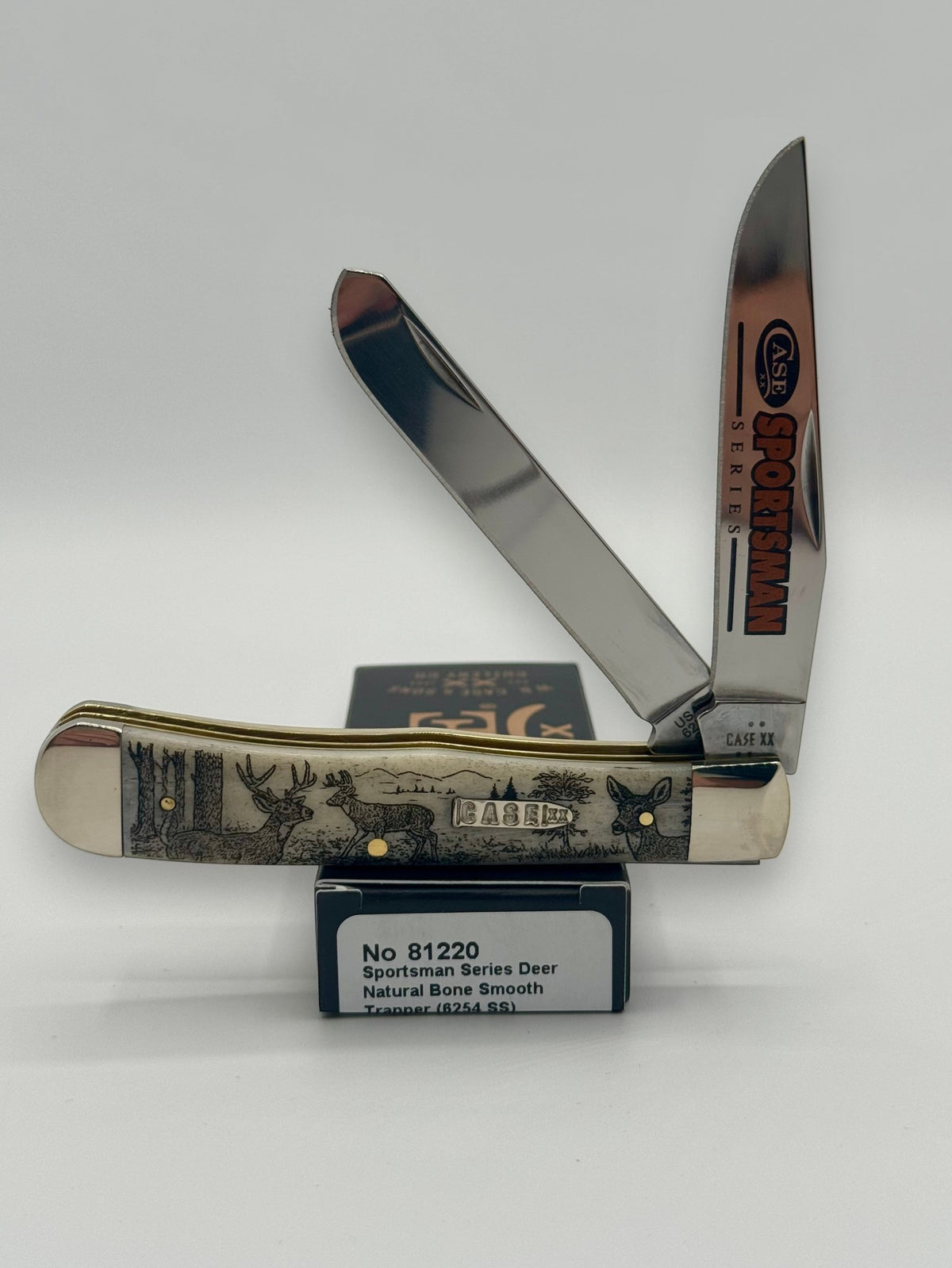 Case XX 81220 Sportsman Deer Bone Trapper — open on Case retail box