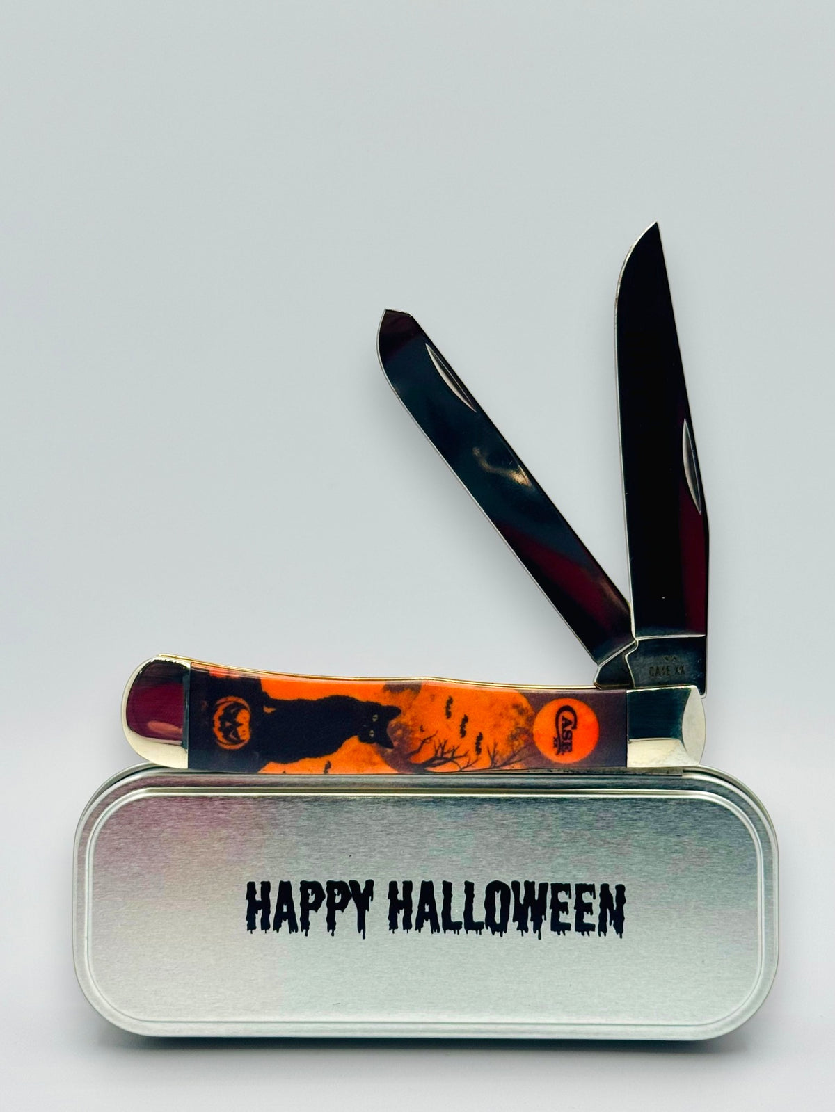 Case XX 13365 Halloween CCI White Synthetic Trapper — open on Happy Halloween collector tin