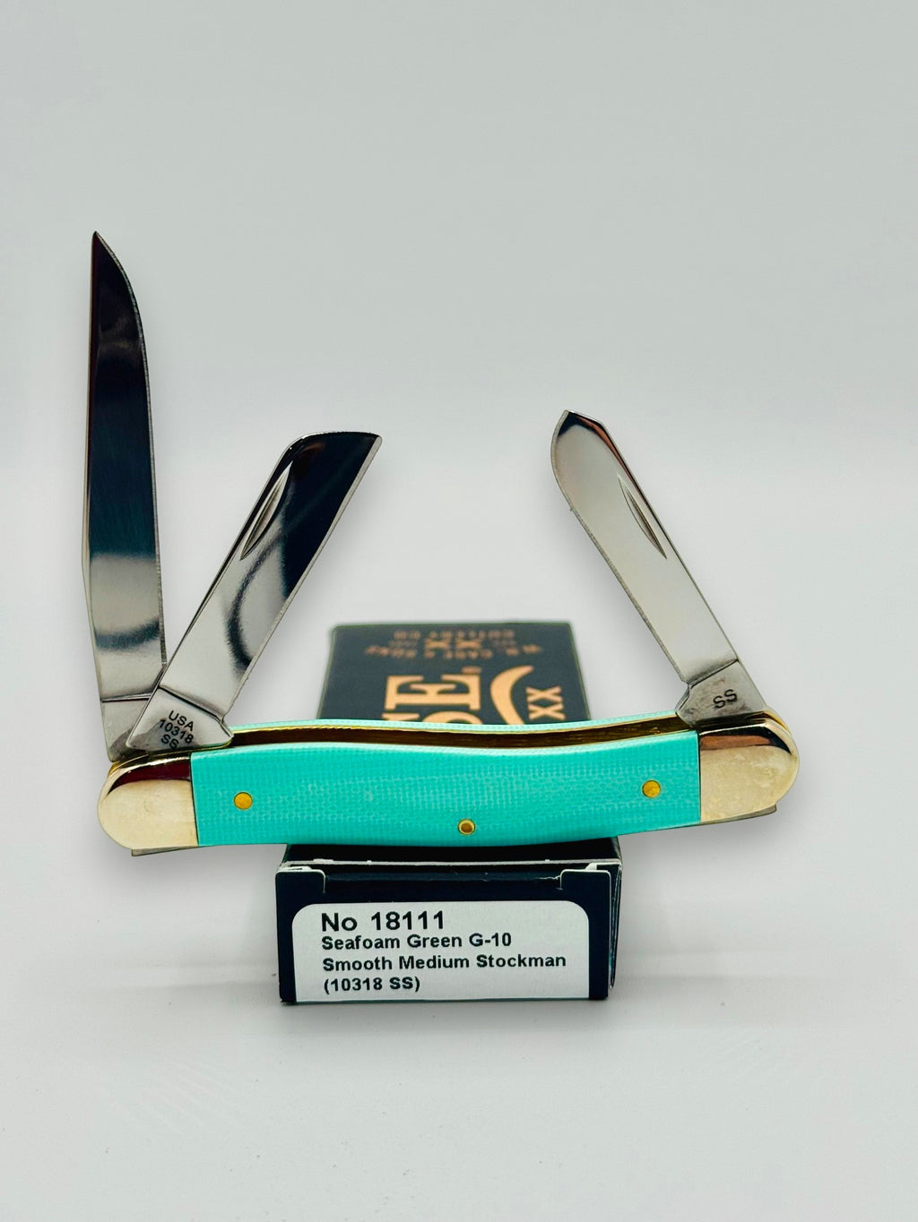 Case XX 18111 Seafoam Green G-10 Medium Stockman — angled open on Case box
