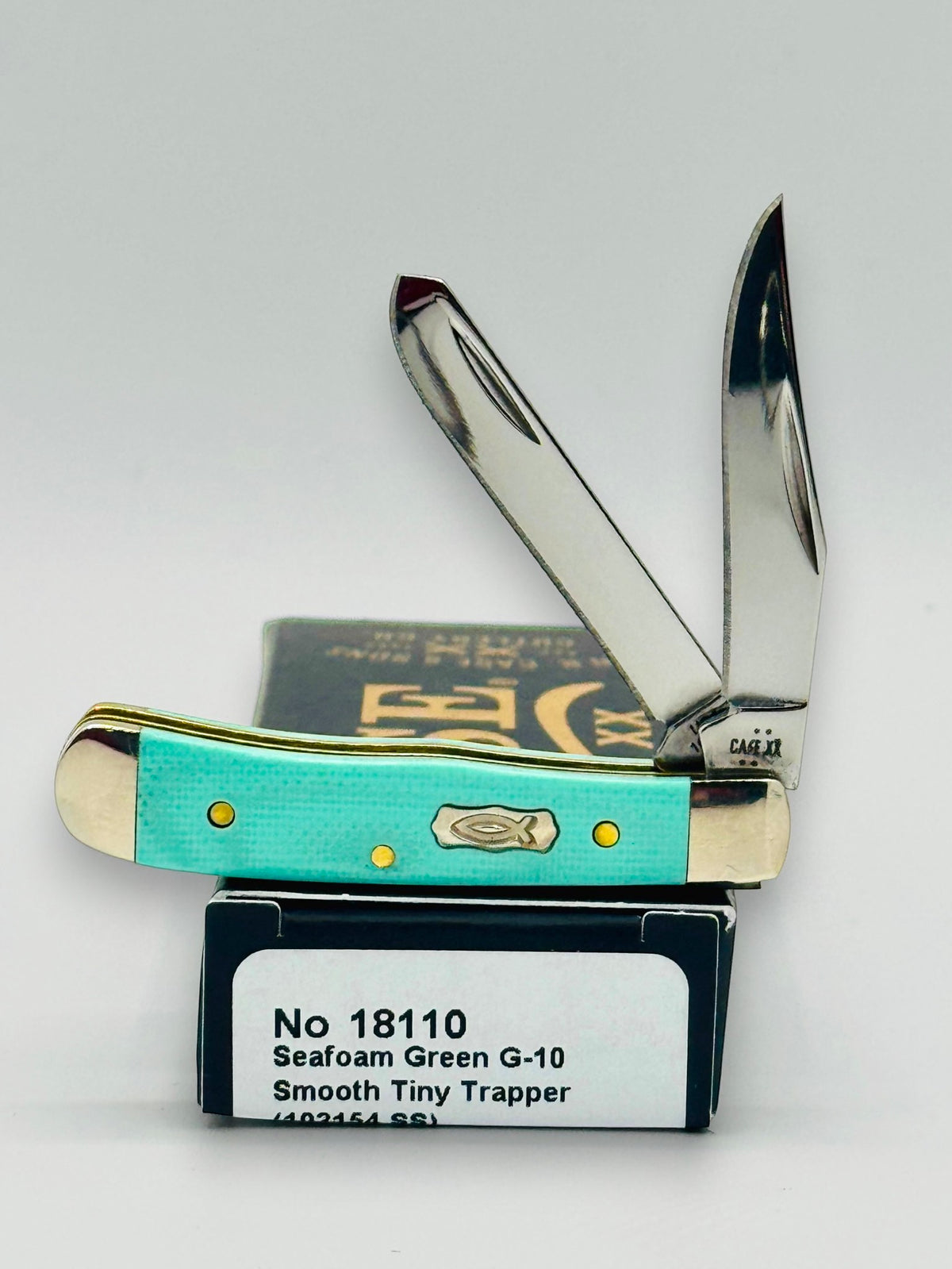 Case XX 18110 Seafoam Green G-10 Tiny Trapper — open on Case retail box