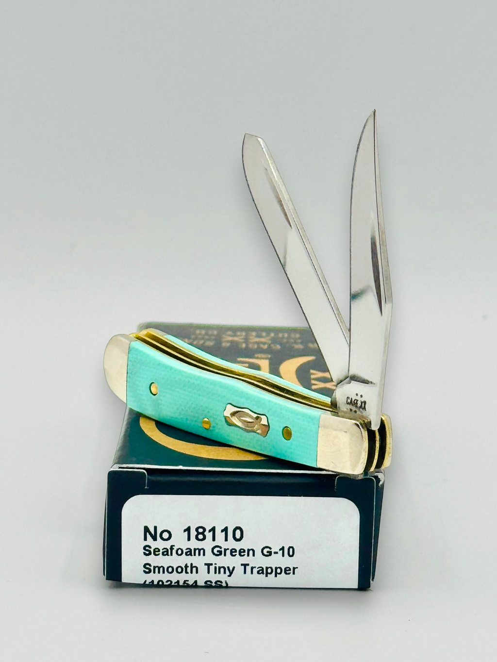 Case XX 18110 Seafoam Green G-10 Tiny Trapper — closed on Case box