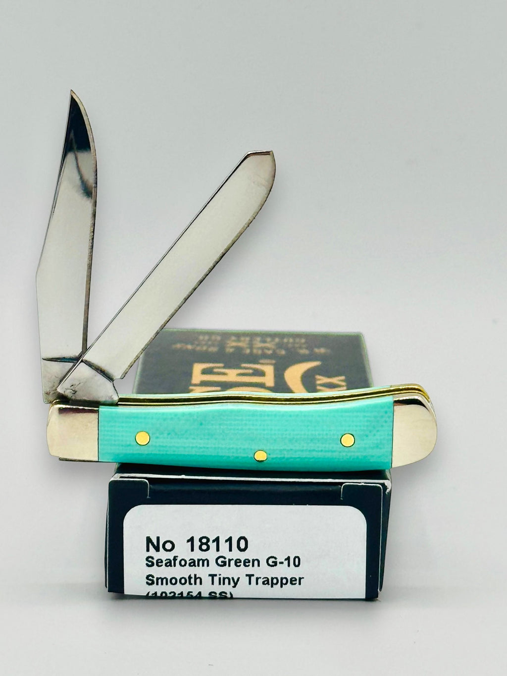 Case XX 18110 Seafoam Green G-10 Tiny Trapper — angled open on Case box