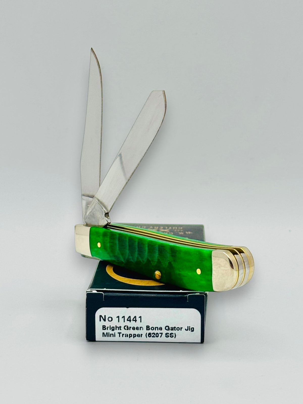 Case XX 11441 Bright Green Bone Gator Jig Mini Trapper — handle and shield detail