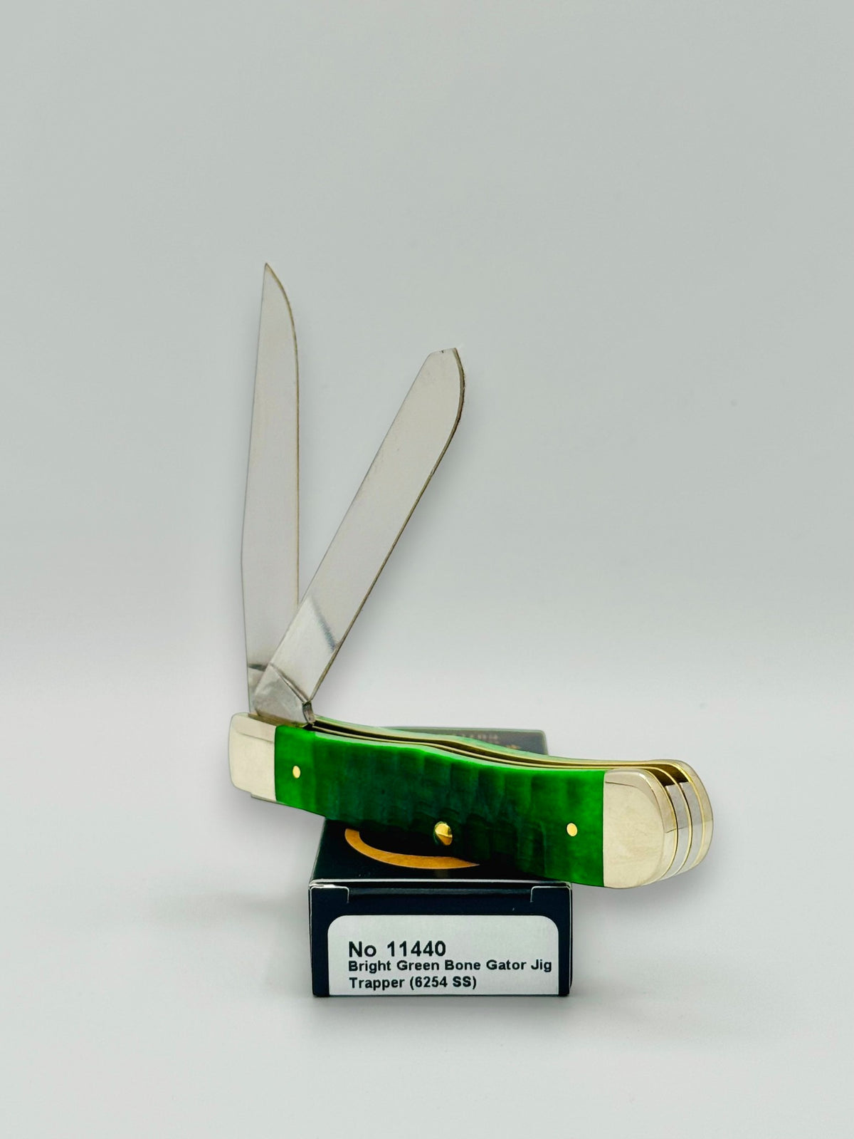 Case XX 11440 Bright Green Bone Gator Jig Trapper — handle and shield detail