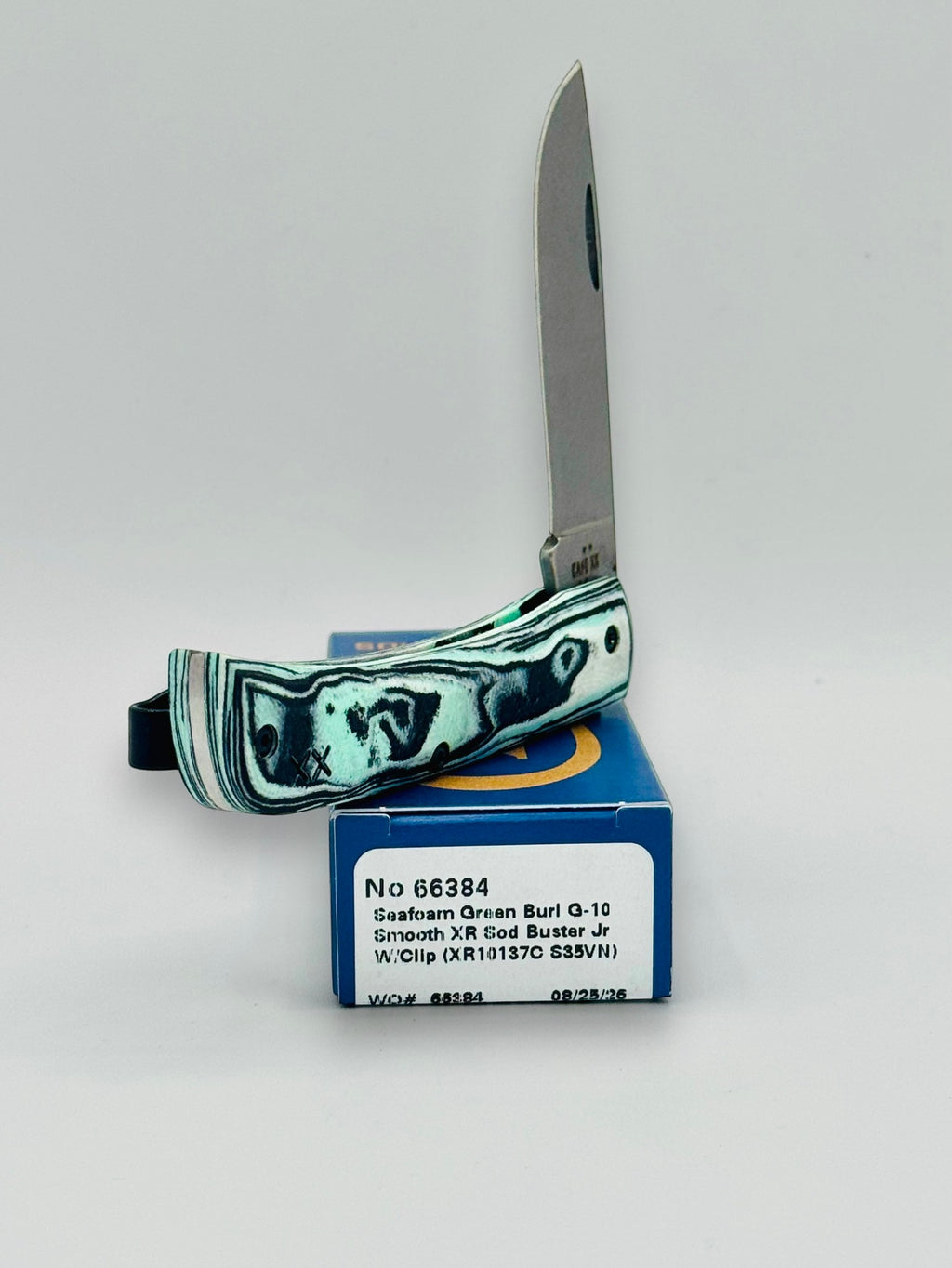 Case XX 66384 Crossroads Seafoam G-10 Sod Buster Jr — blade detail on Case box