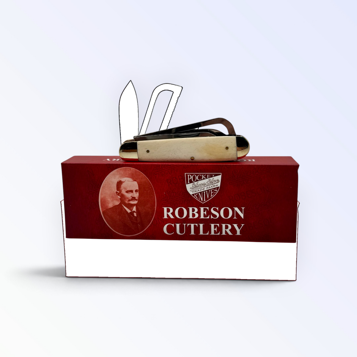 Pigeon Roost Knives Robeson Gamecock pocket knife with white smooth bone handle resting on its red branded box.